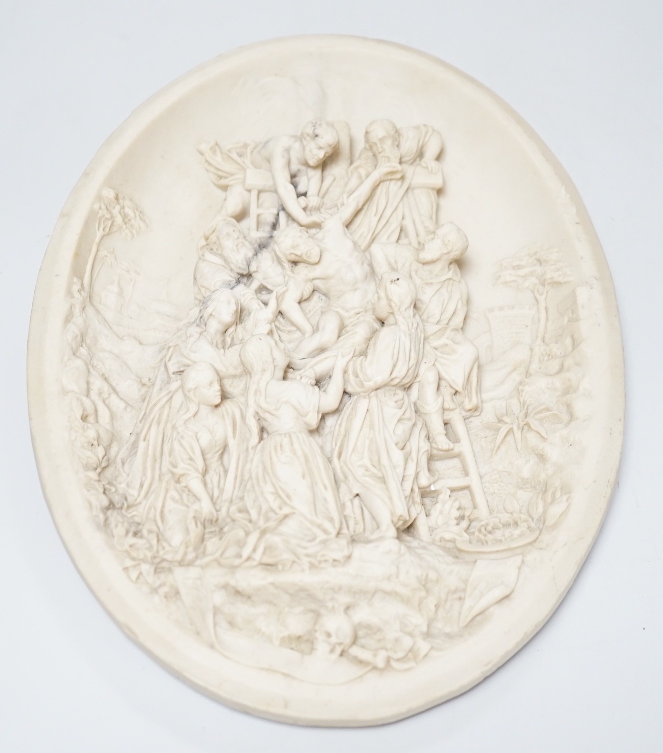 A reproduction reconstituted marble oval plaque with inset coin to reverse, 30cm